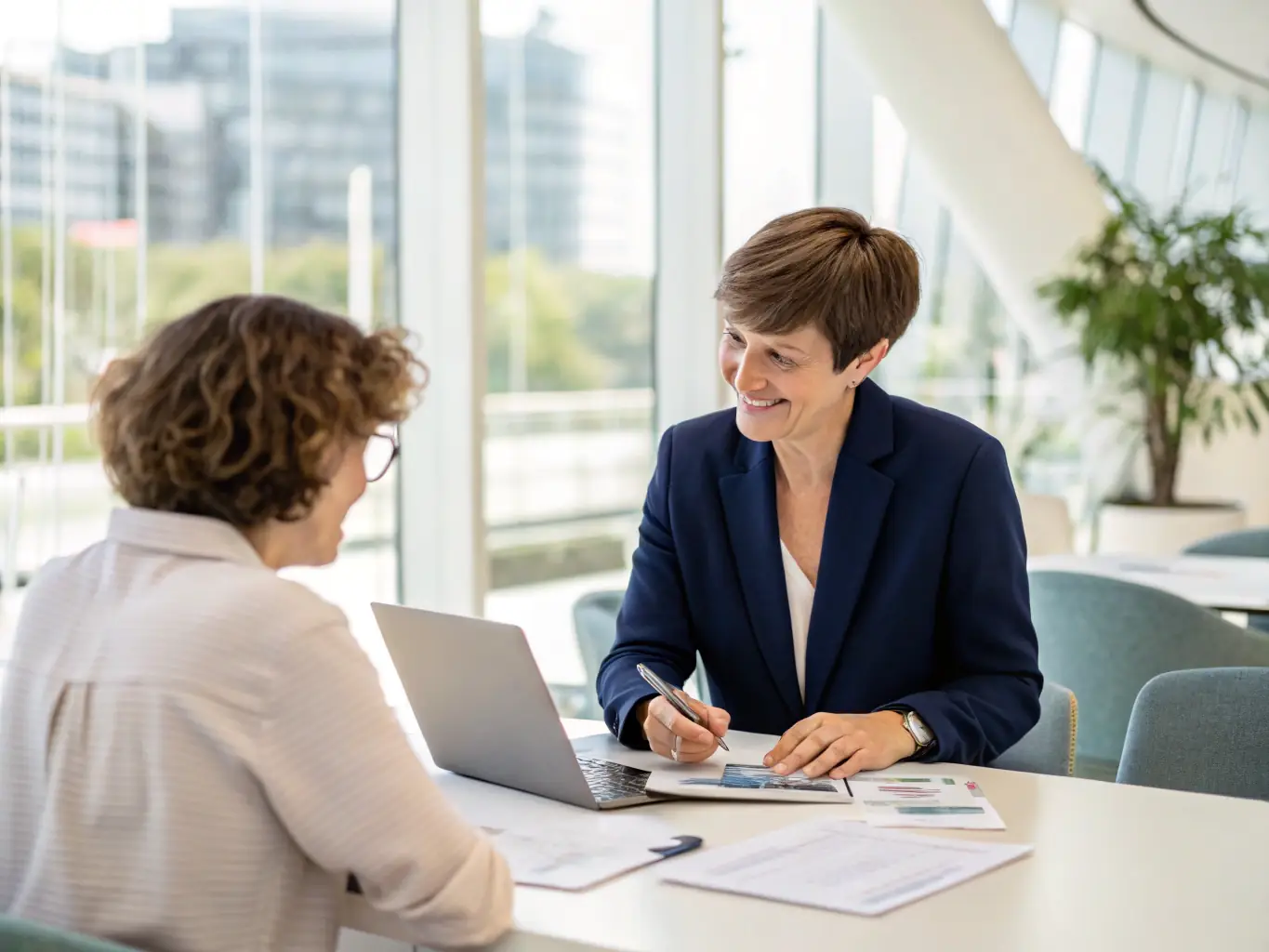 A professional financial advisor in a modern office setting, reviewing investment portfolios with a client, showcasing charts and graphs on a large screen.